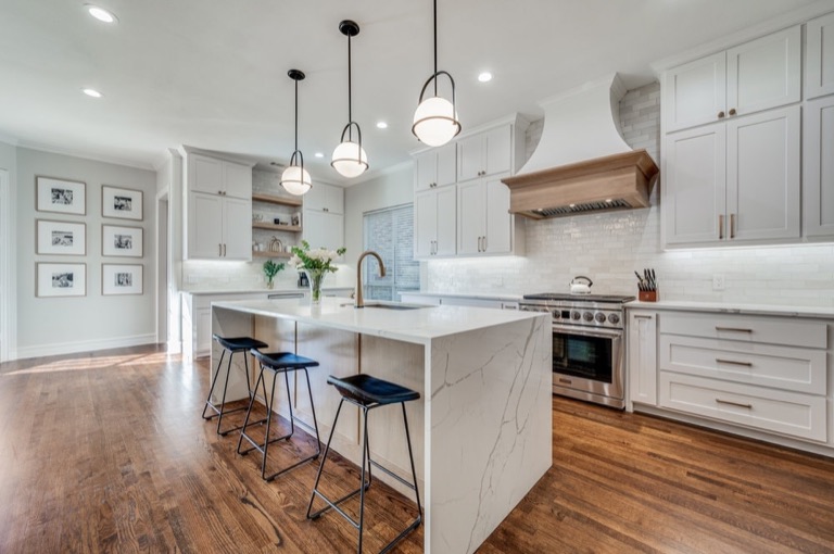 Bright modern kitchen remodel with custom cabinetry, island, plumbing fixtures, and wood floors