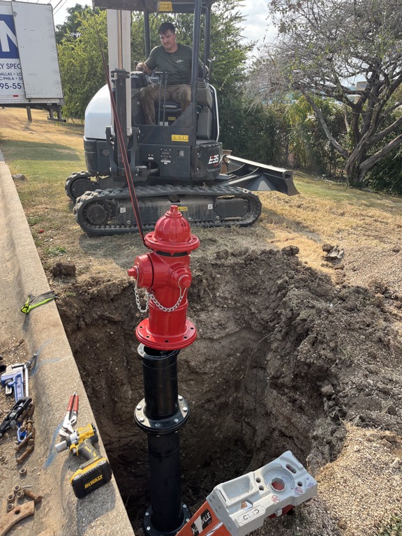 New private hydrant mounted on a below-grade riser during commercial installation